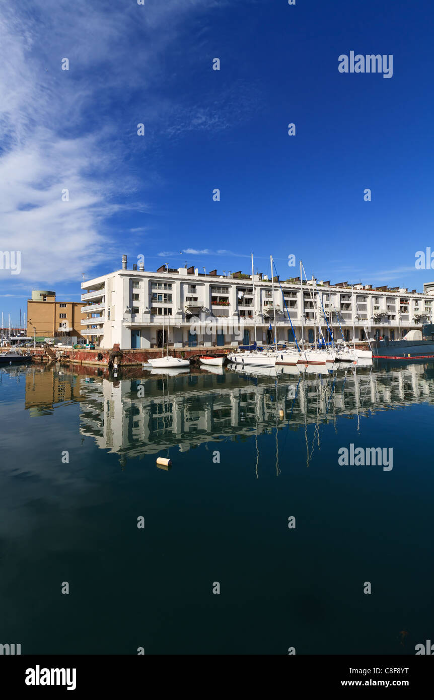 warehouse, fishing boat and sail boat in Genoa port, Italy Stock Photo