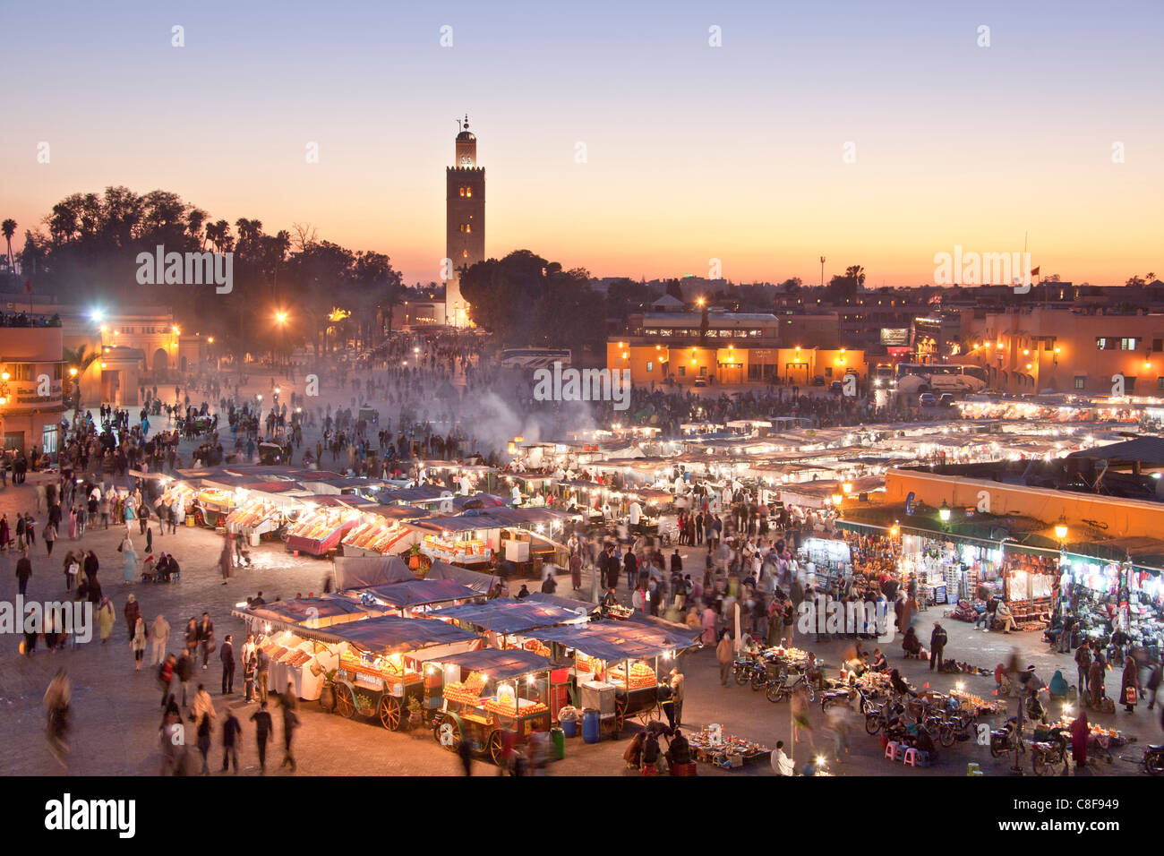 Morocco, North Africa, Africa, Marrakech, Medina, business, trade, shop, Djemaa el Fna, place, Koutobia, tower, rook, in the eve Stock Photo