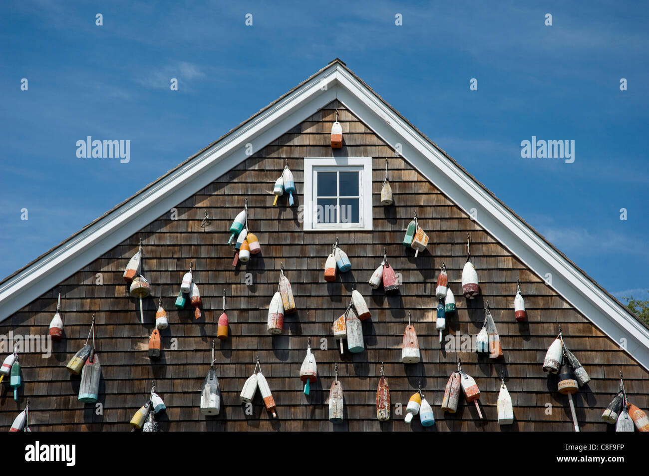 Painted wooden buoys on a shingled building in Sag Harbor, Long Island, New York State, United States of America Stock Photo