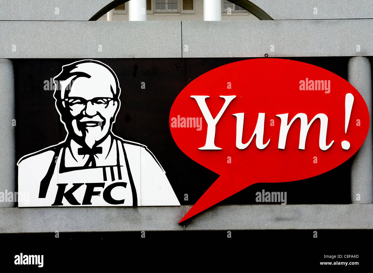 Sign for Yum! Brands Restaurant displaying image of KFC founder Colonel