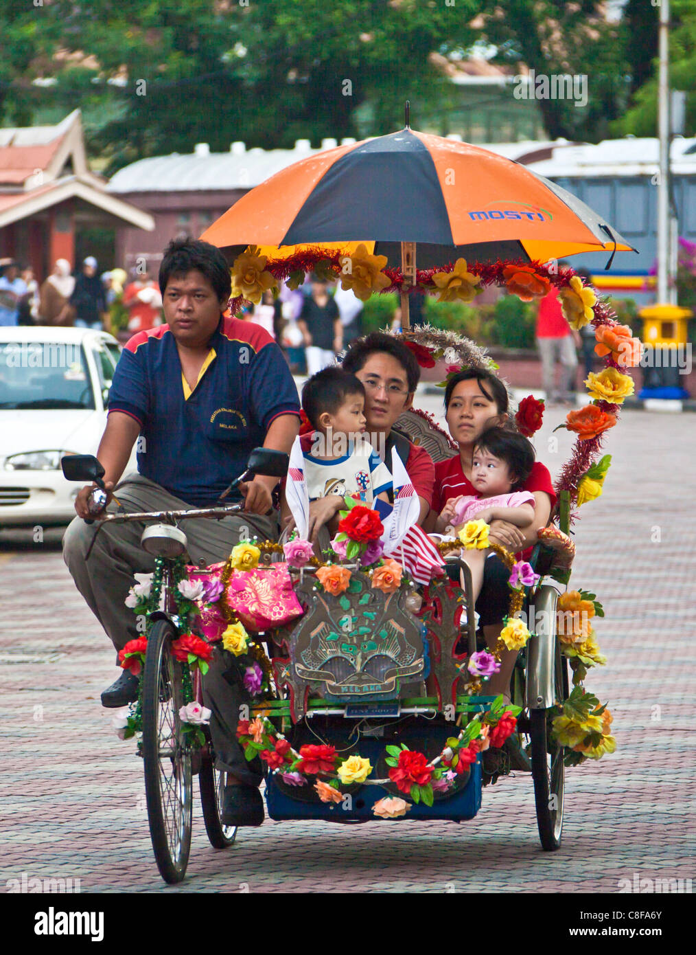 Malaysia, Asia, Melaka, city, Trishaw, ricksha, transport, traditional, family, seated, sedentary, driver, sunshade, children, a Stock Photo