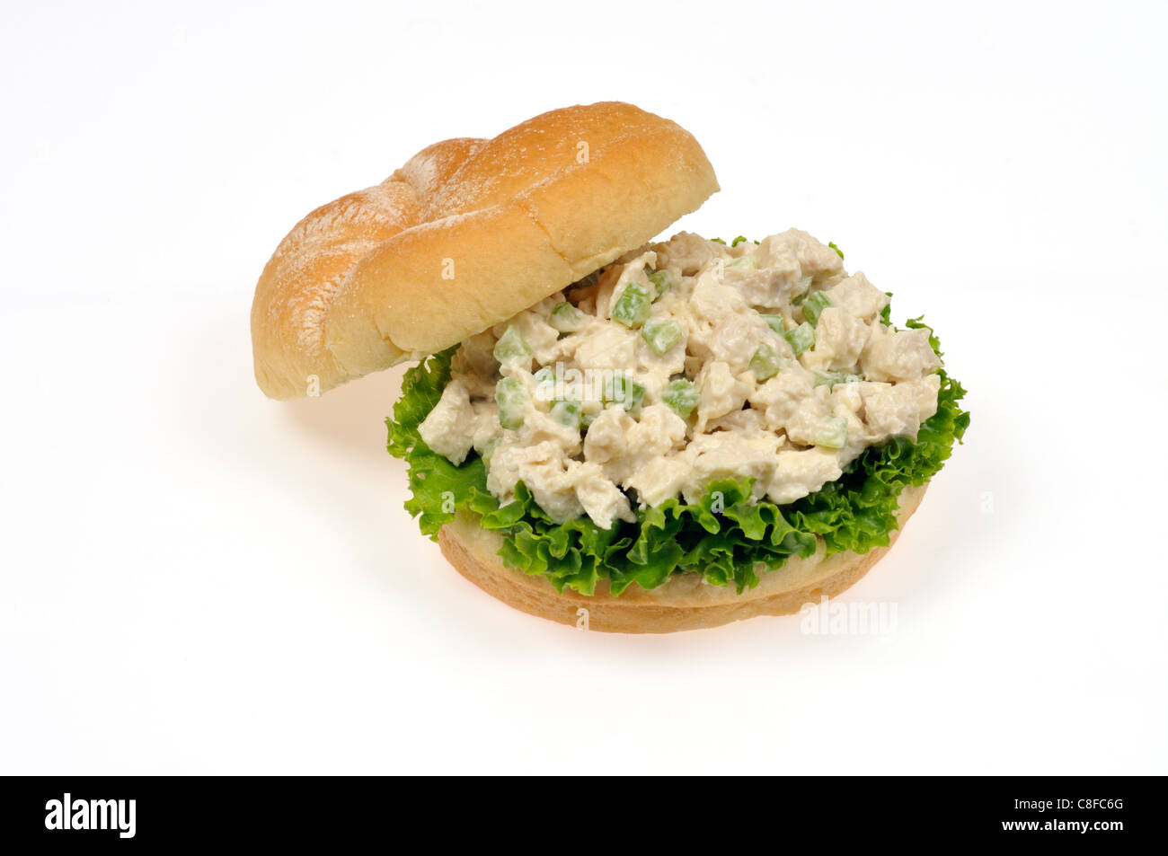 Chicken salad sandwich with mayo, lettuce & celery in bread bulkie roll open with top off on white background, cutout. Stock Photo
