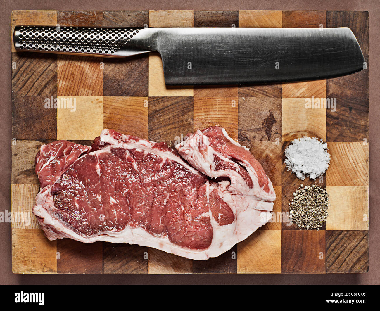 Sirloin Steak on Chopping Board with Knife Stock Photo