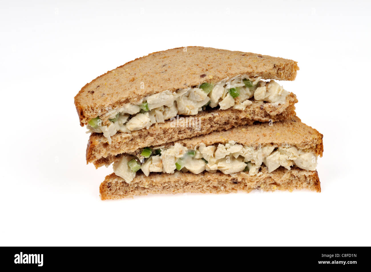 Chunky chicken salad sandwich on wholemeal bread on white background cutout. Stock Photo