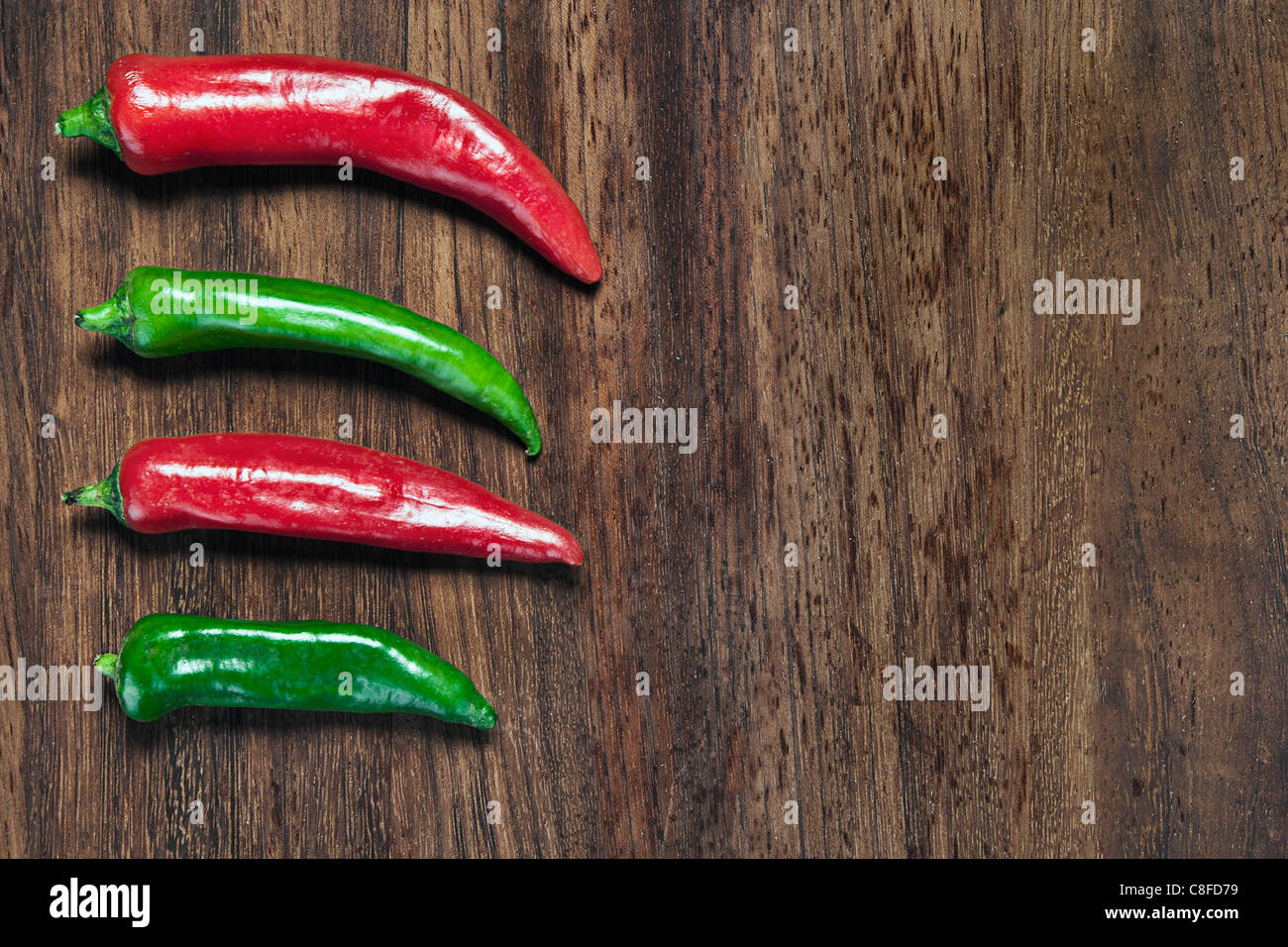 Green and Red Chillis on Chopping Board Stock Photo