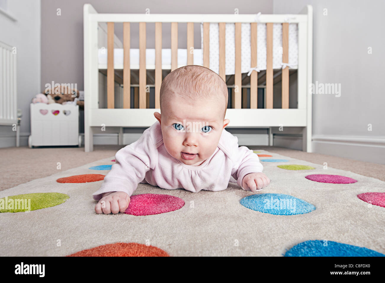 Babys First Crawling Attempts in Nursery Stock Photo