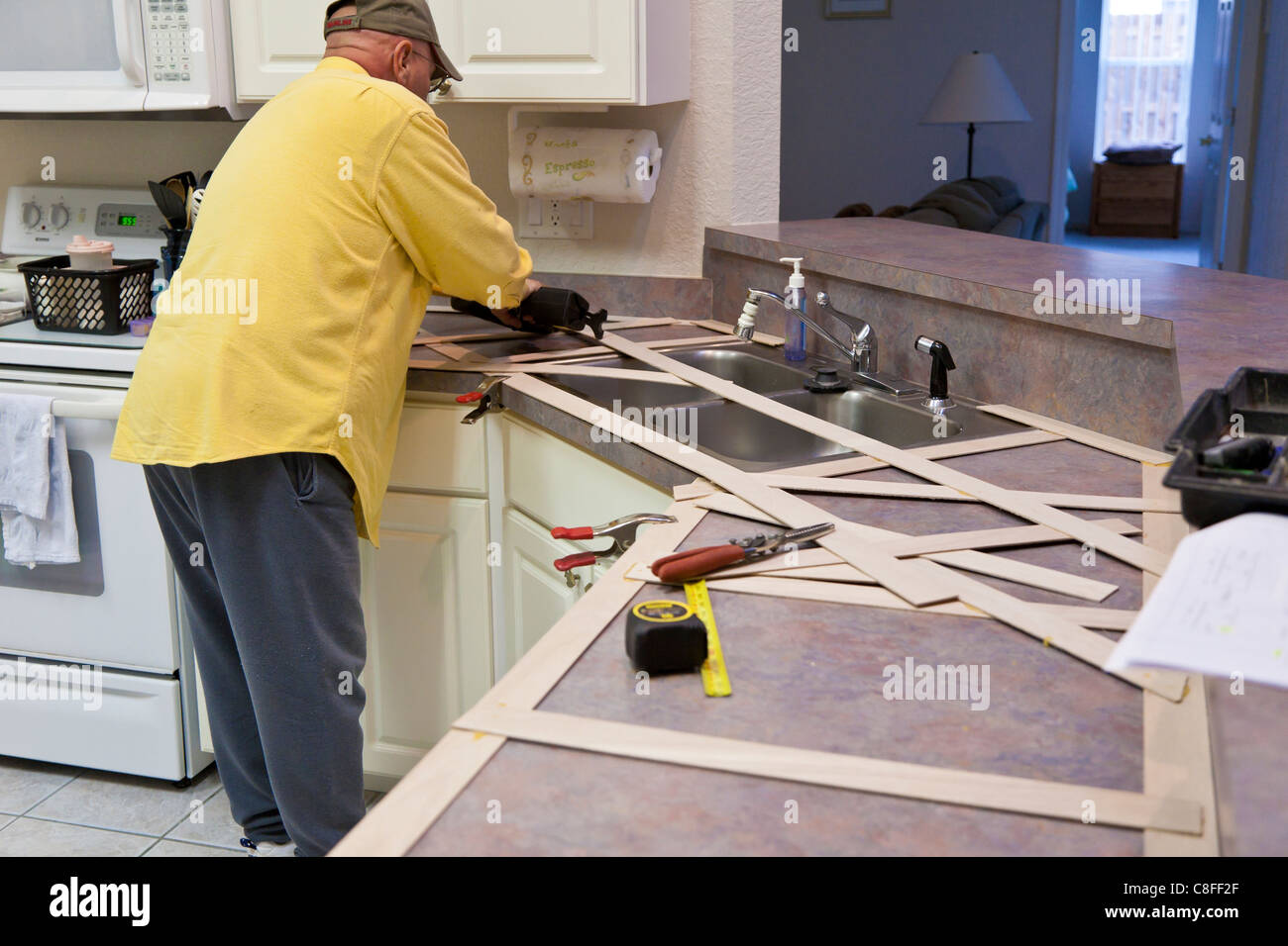 Man Builds A Wooden Template For Use In Making New Granite Counter
