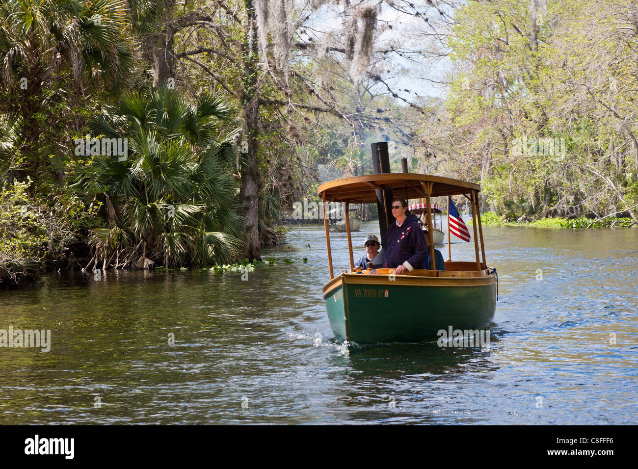 Woman standing in bow of classic steam powered boat on Silver River near Silver Springs Attractions in Ocala Florida Stock Photo