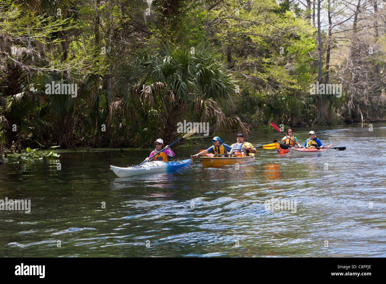 Several kayakers and a canoe on Silver River near Silver Springs State Park in Ocala Florida Stock Photo