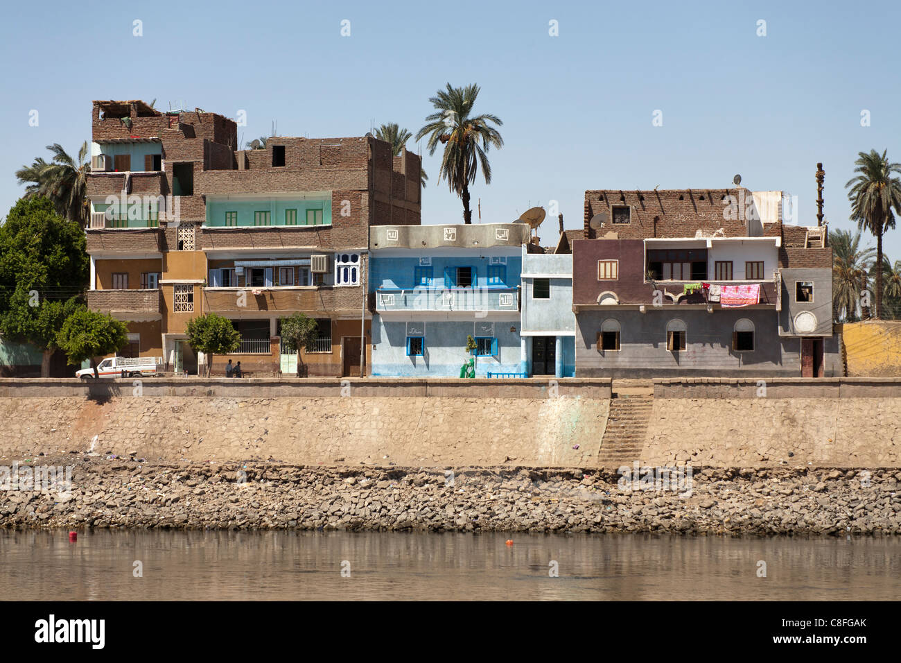Traditional Egyptian houses with multi colour facades and washing hanging from balconies, overlooking the Nile river, Egypt Stock Photo