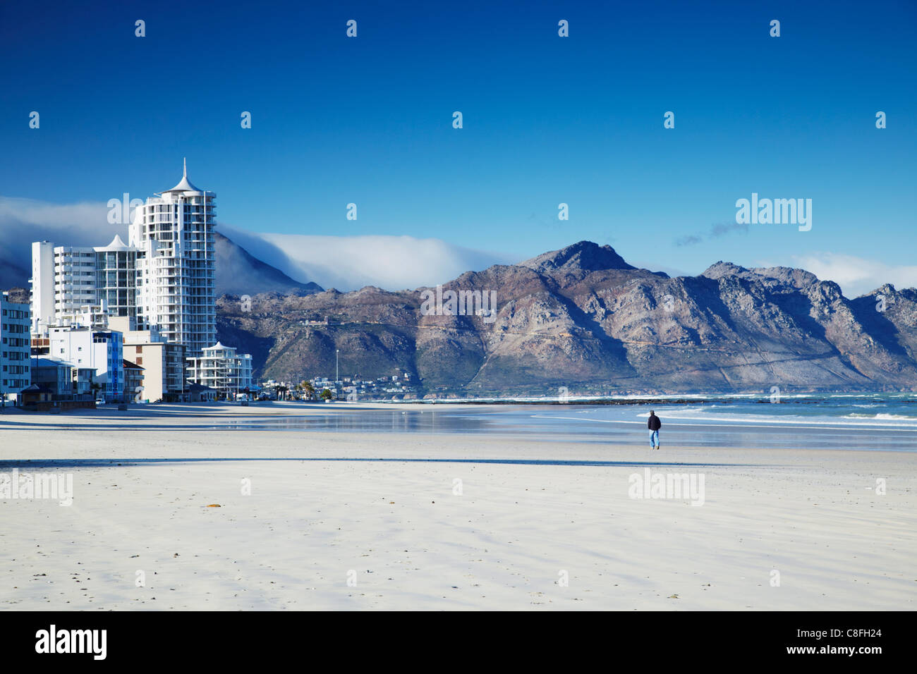 Man walking on beach, Strand, Western Cape, South Africa Stock Photo - Alamy