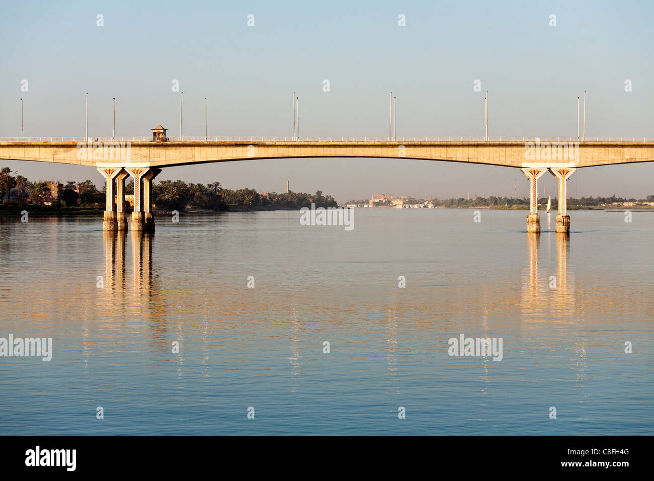 Section of Luxor bridge seen from the middle of the Nile reflected in calm water, Luxor, Egypt, Africa Stock Photo