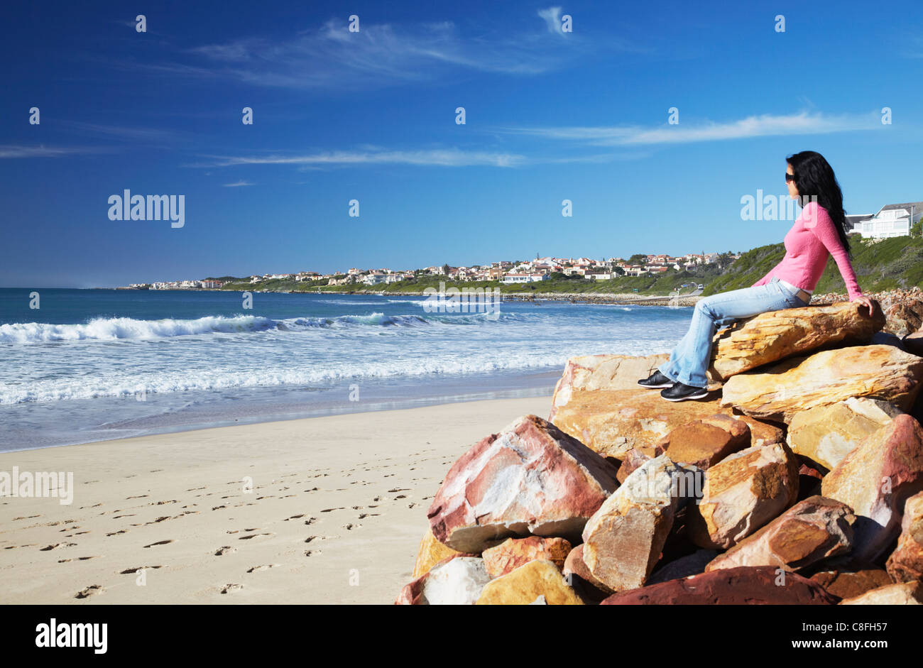 Person sitting on rocks hi-res stock photography and images - Alamy