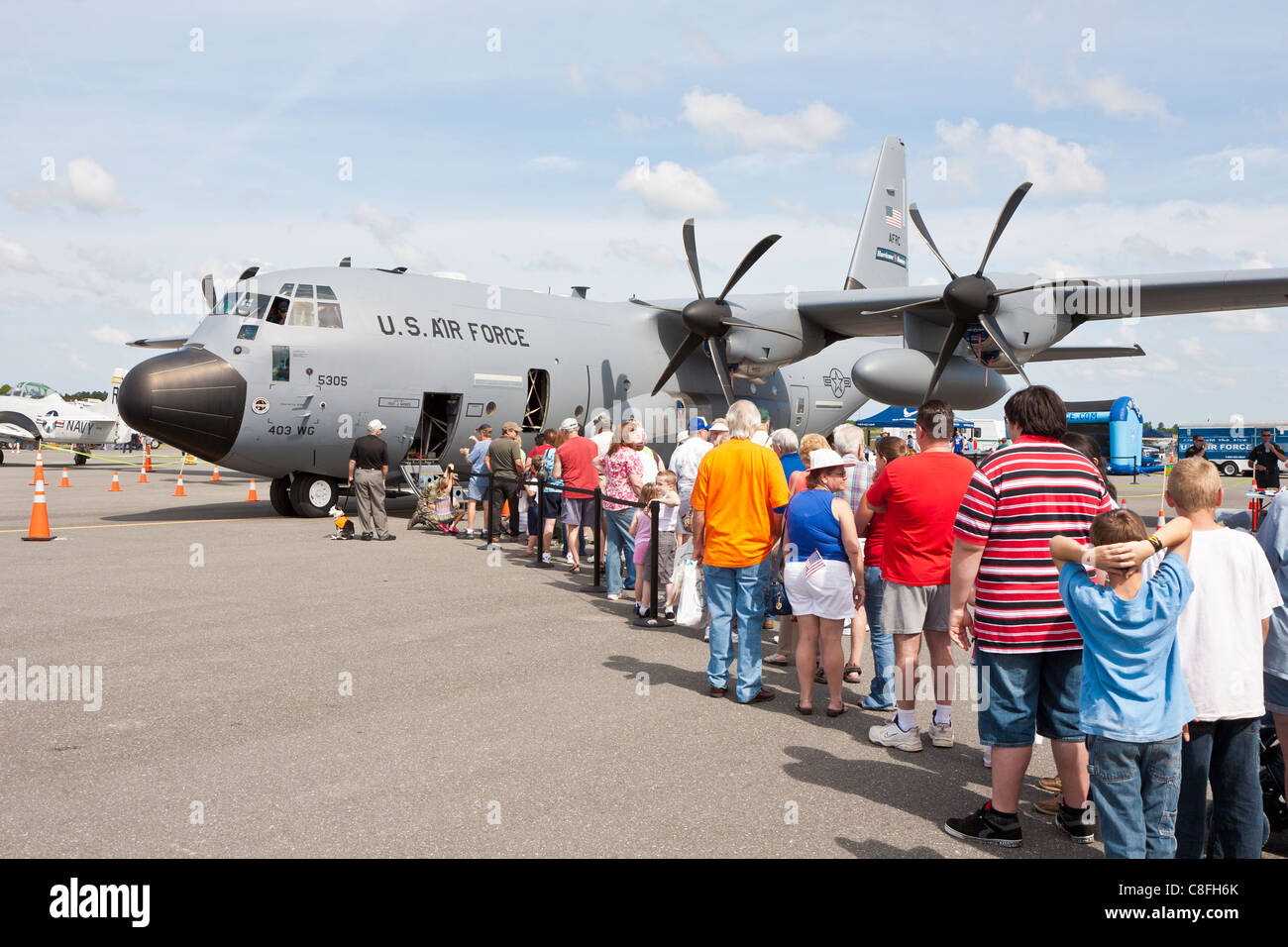 People line up to walk through a Hurricane Hunter Lockheed WC-130 Weatherbird aircraft displayed at air show in Ocala, Florida Stock Photo