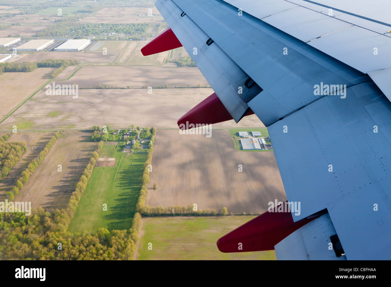 Southwest jet wing with flaps down over rural area near Columbus, Ohio Stock Photo