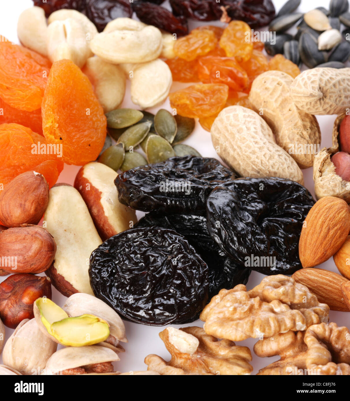 Group of different dried fruits and nuts on a white background. Stock Photo