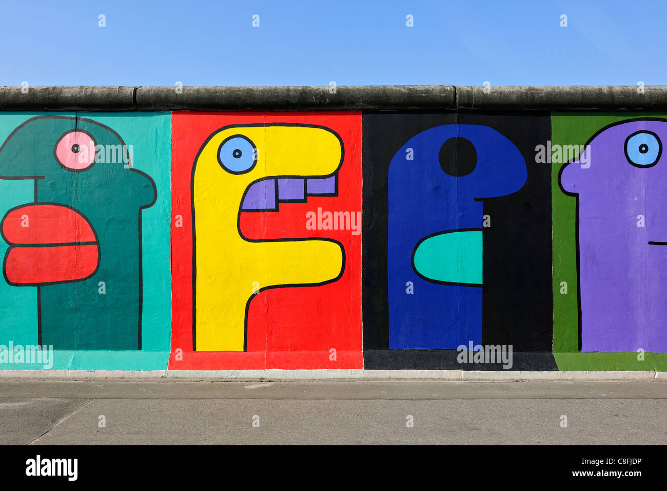 Detail of painted faces graffiti on Berlin Wall at East Side Gallery