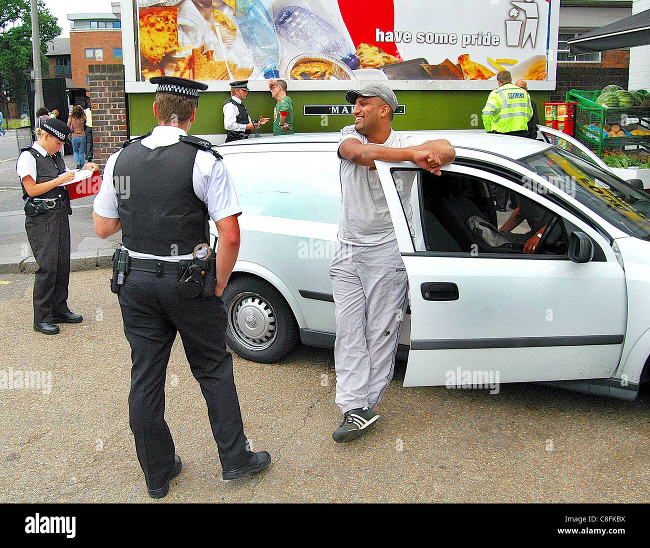 Police question a driver in a spot check on passing cars in Bounds Green, north London. The conversation was good natured. Stock Photo