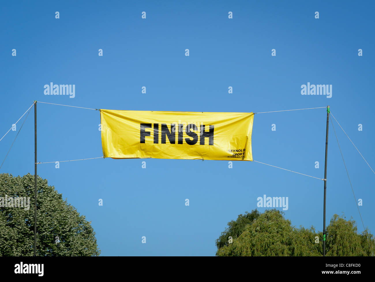Finish Line Banner Set Against Blue Sky Stock Photo