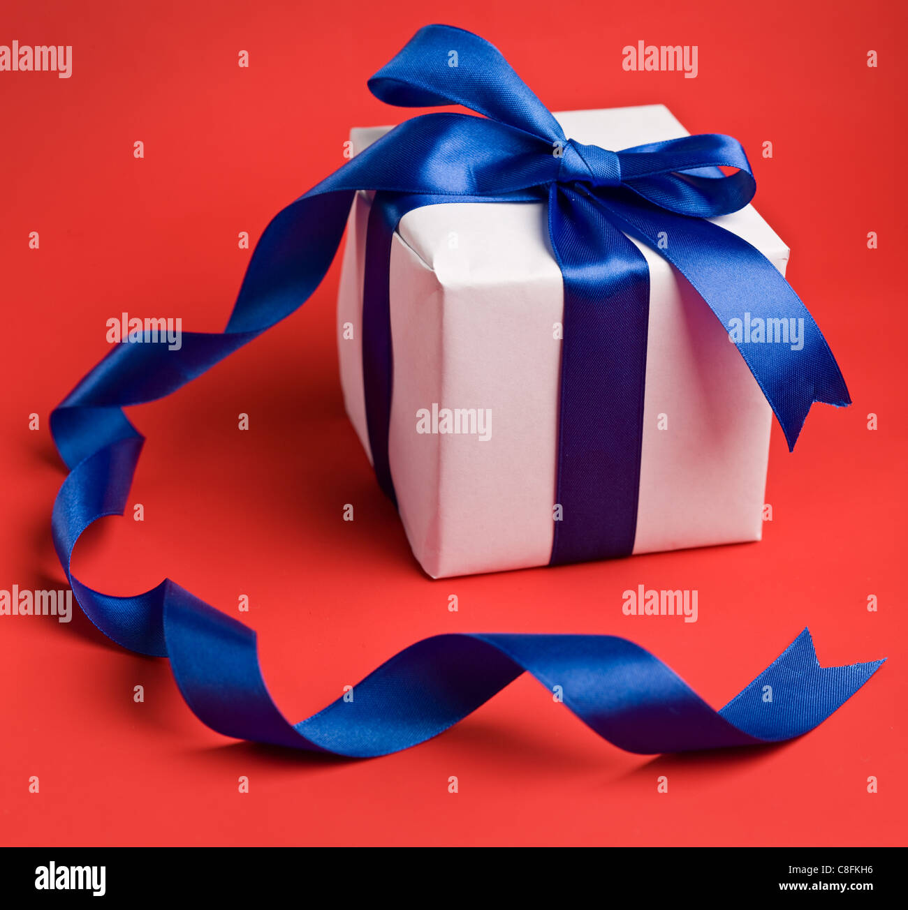 Gift box with a red background. Stock Photo