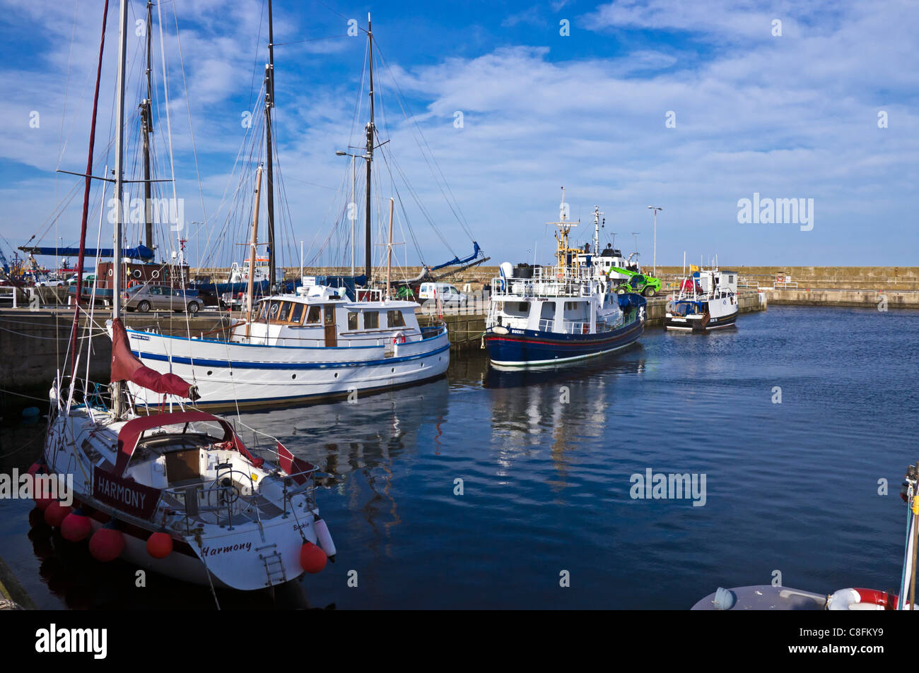 Yachts and trawlers moored at the dockside in Buckie Harbour Moray Scotland Stock Photo