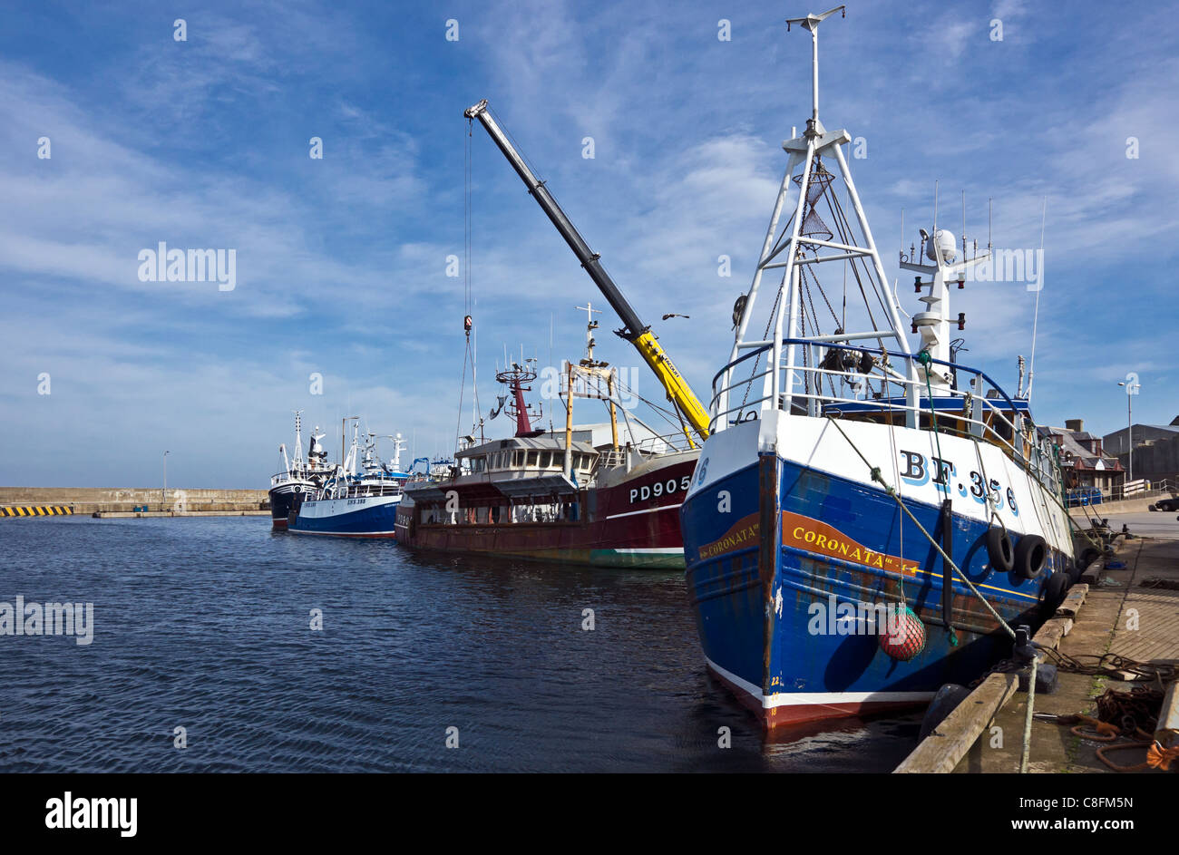 Trawlers tied up along the harbour quay in Macduff Aberdeenshire Stock Photo