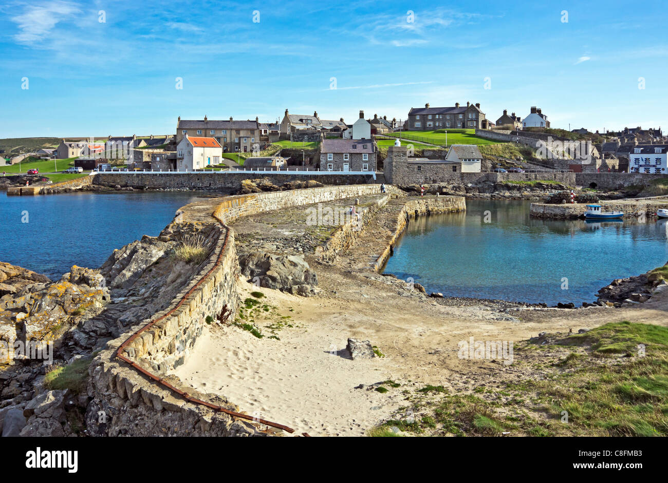 View looking east of the breakwater of the old harbour in Portsoy Scotland Stock Photo