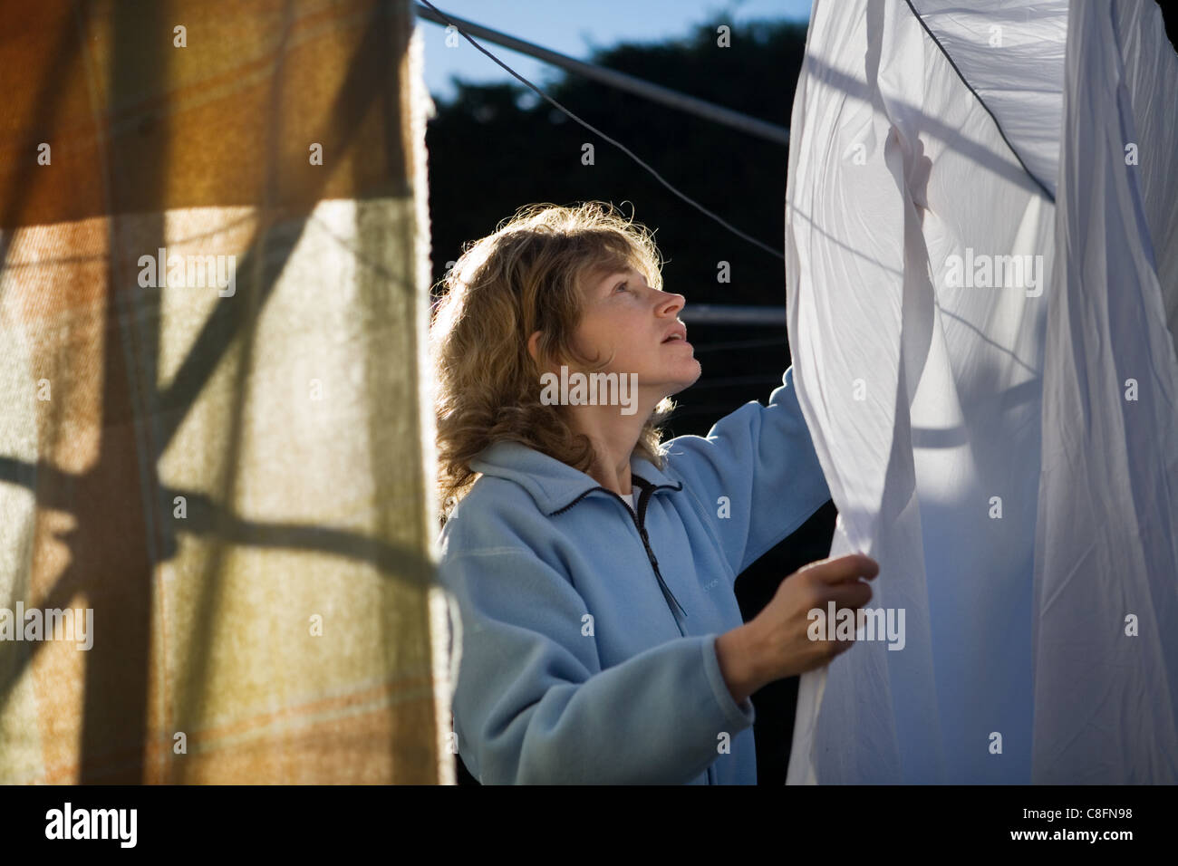 Woman drying clothes, New Zealand Stock Photo