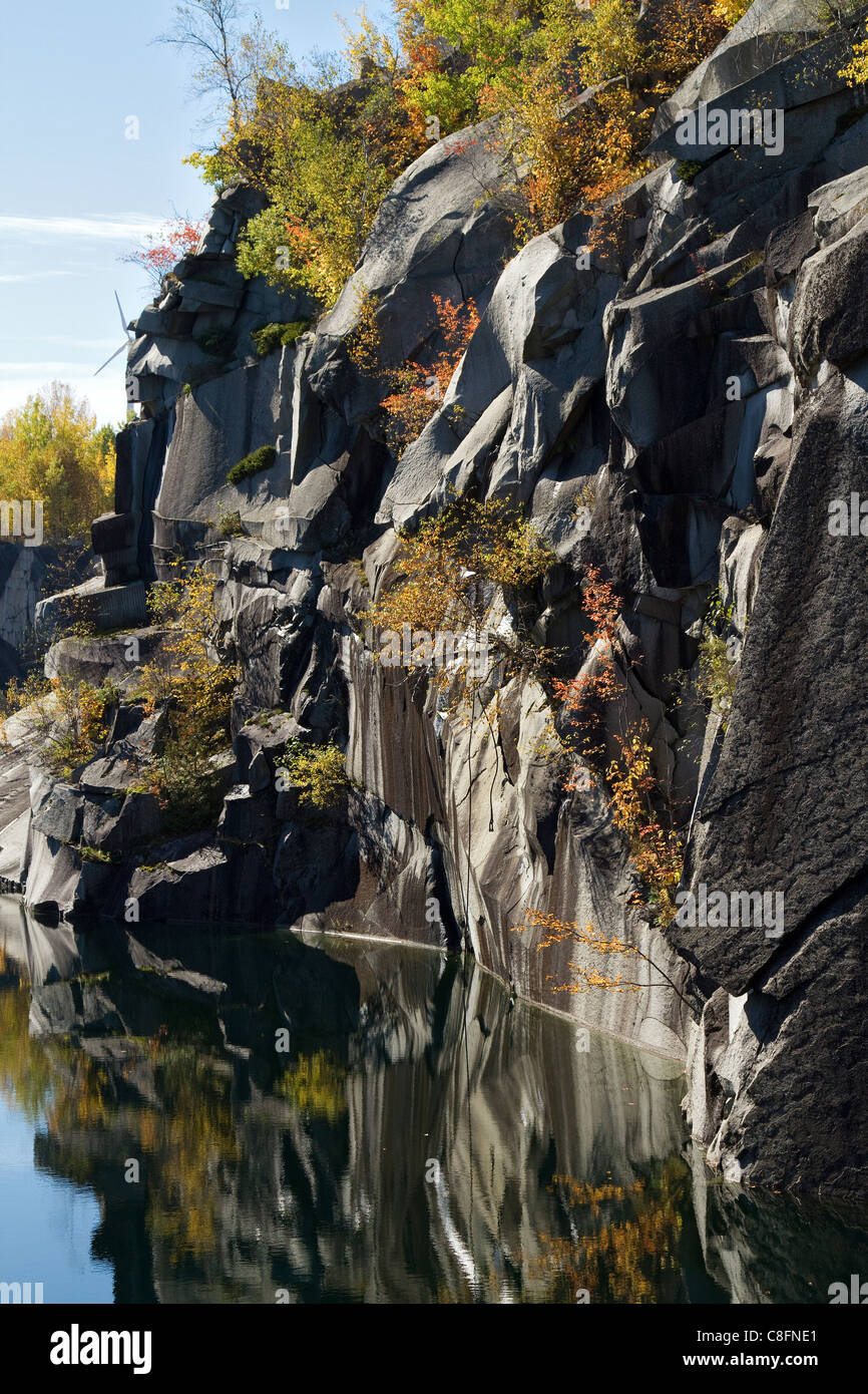 Quarry landscape of Granite rock, stone, at abandoned quarry in Barre, Vermont with autumn, fall, foliage colors. Stock Photo