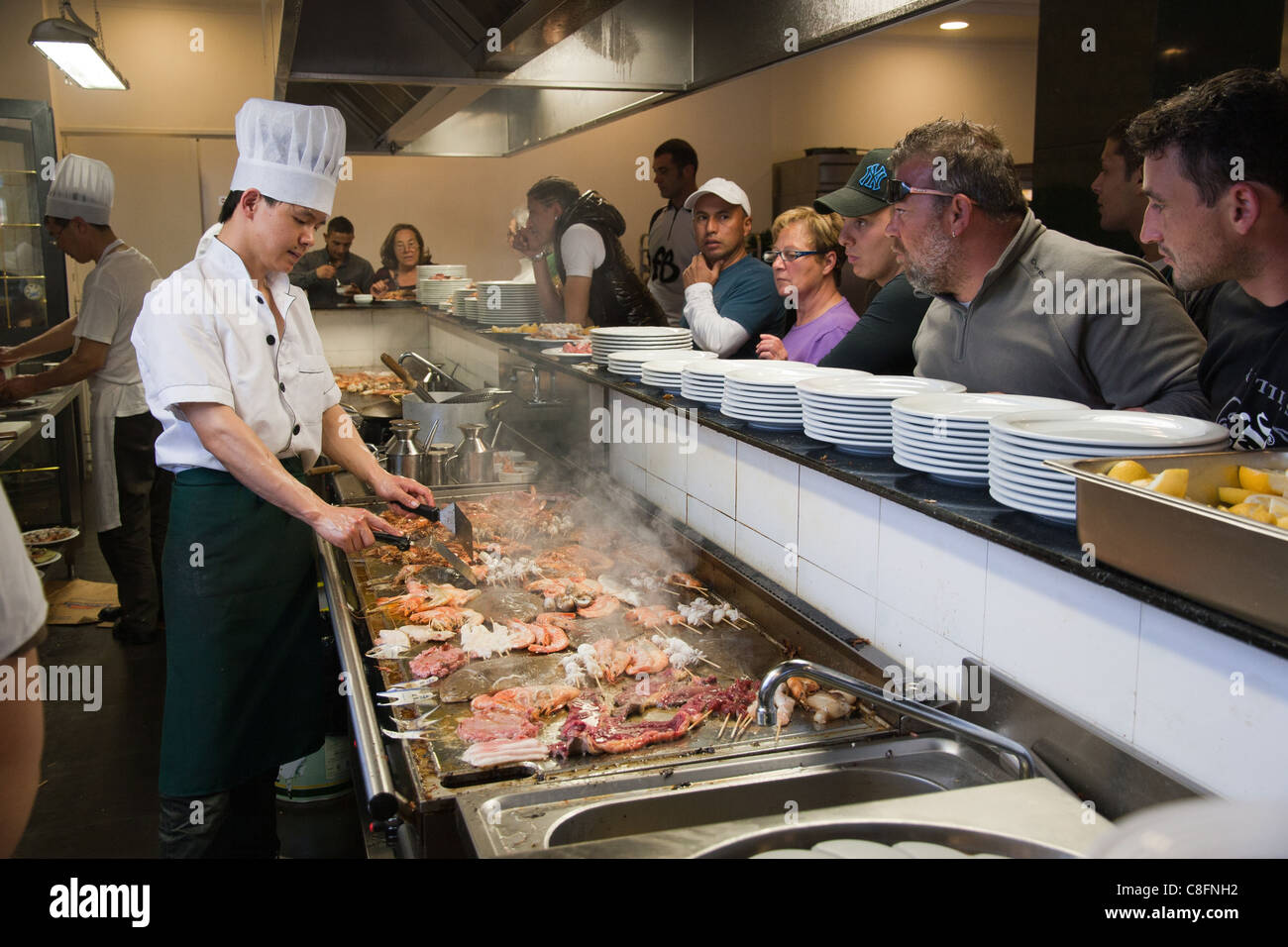 chinese-chef-cooking-food-on-grill-in-a-chinese-restaurant-in-rome
