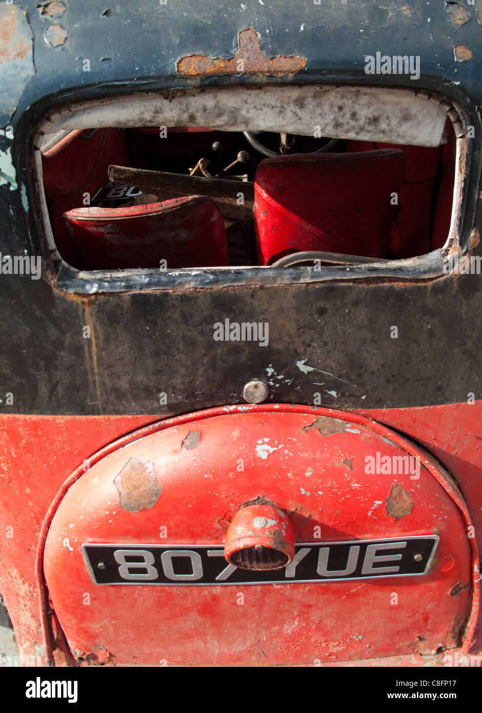 Rear view of a red, black and rust Austin 7 saloon car/automobile with ...