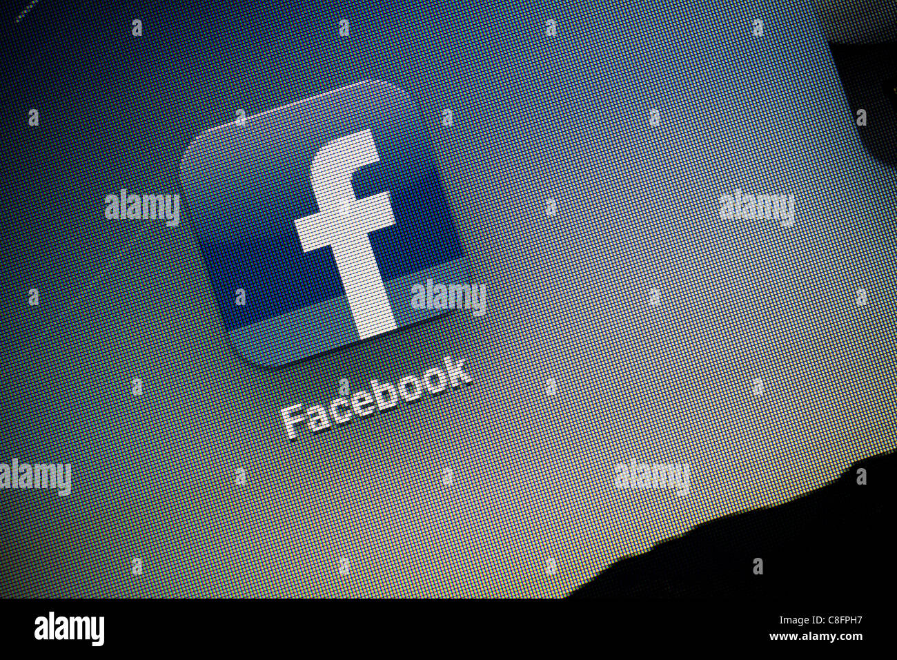 Macro shot of Facebook logo on the screen of Apple Ipad2. Facebook is largest and most used social network. Stock Photo