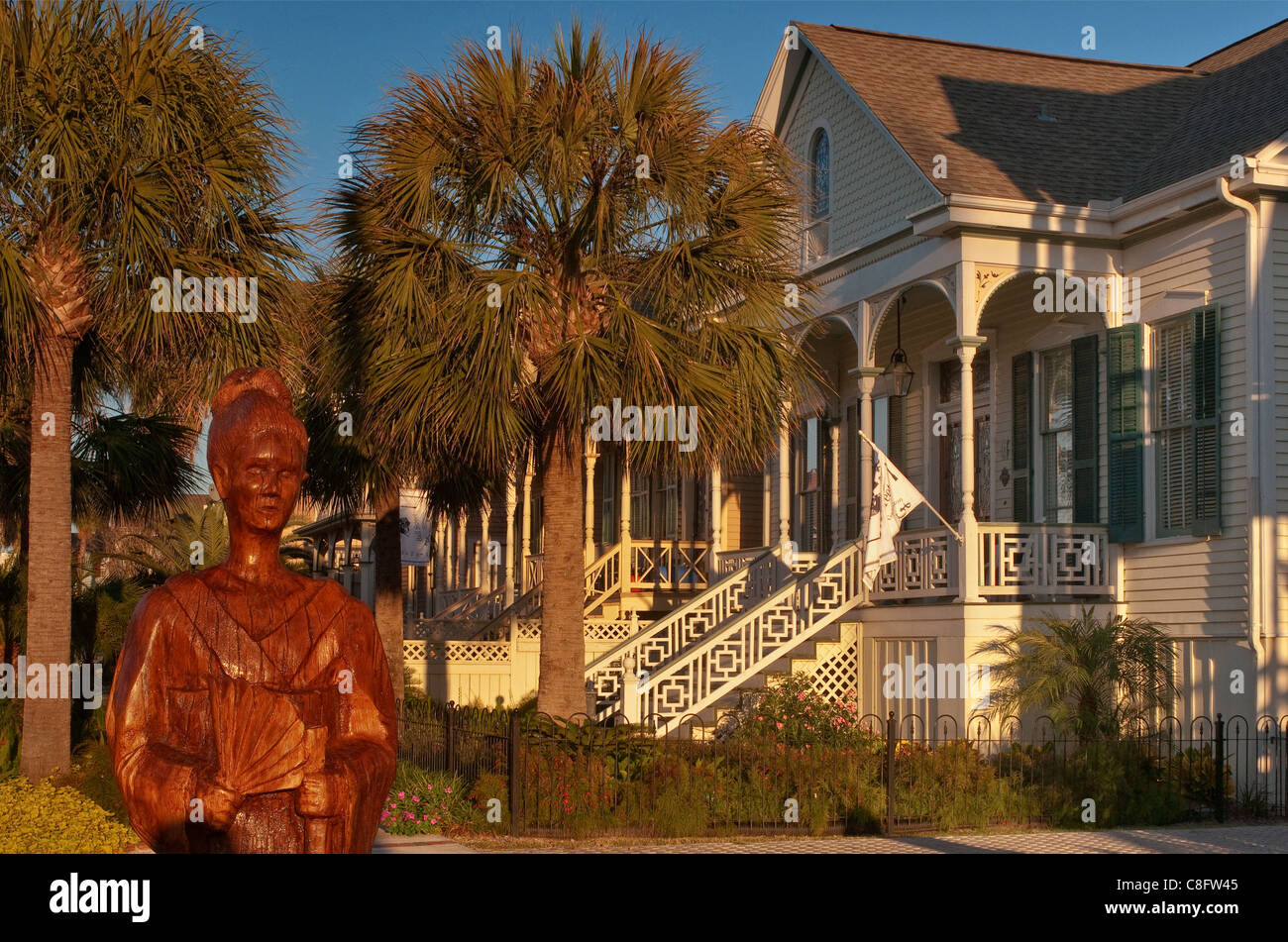 Sculpture of Japanese geisha, carved from live oak tree killed by Hurricane Ike in 2008, gingerbread house Galveston, Texas, USA Stock Photo