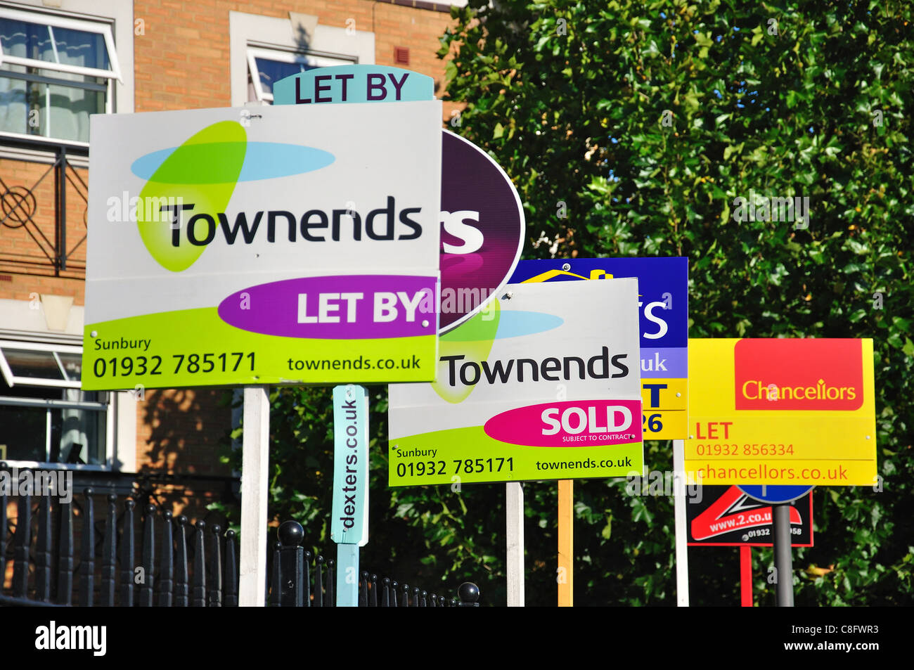 Estate agent signs outside apartments, Staines Road West, SunburyonThames, Surrey, England