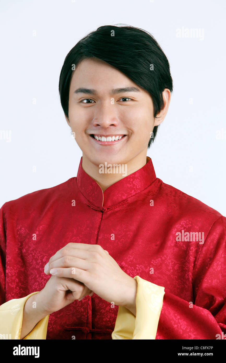 man in Chinese traditional clothes greeting you a Chinese New Year Stock Photo