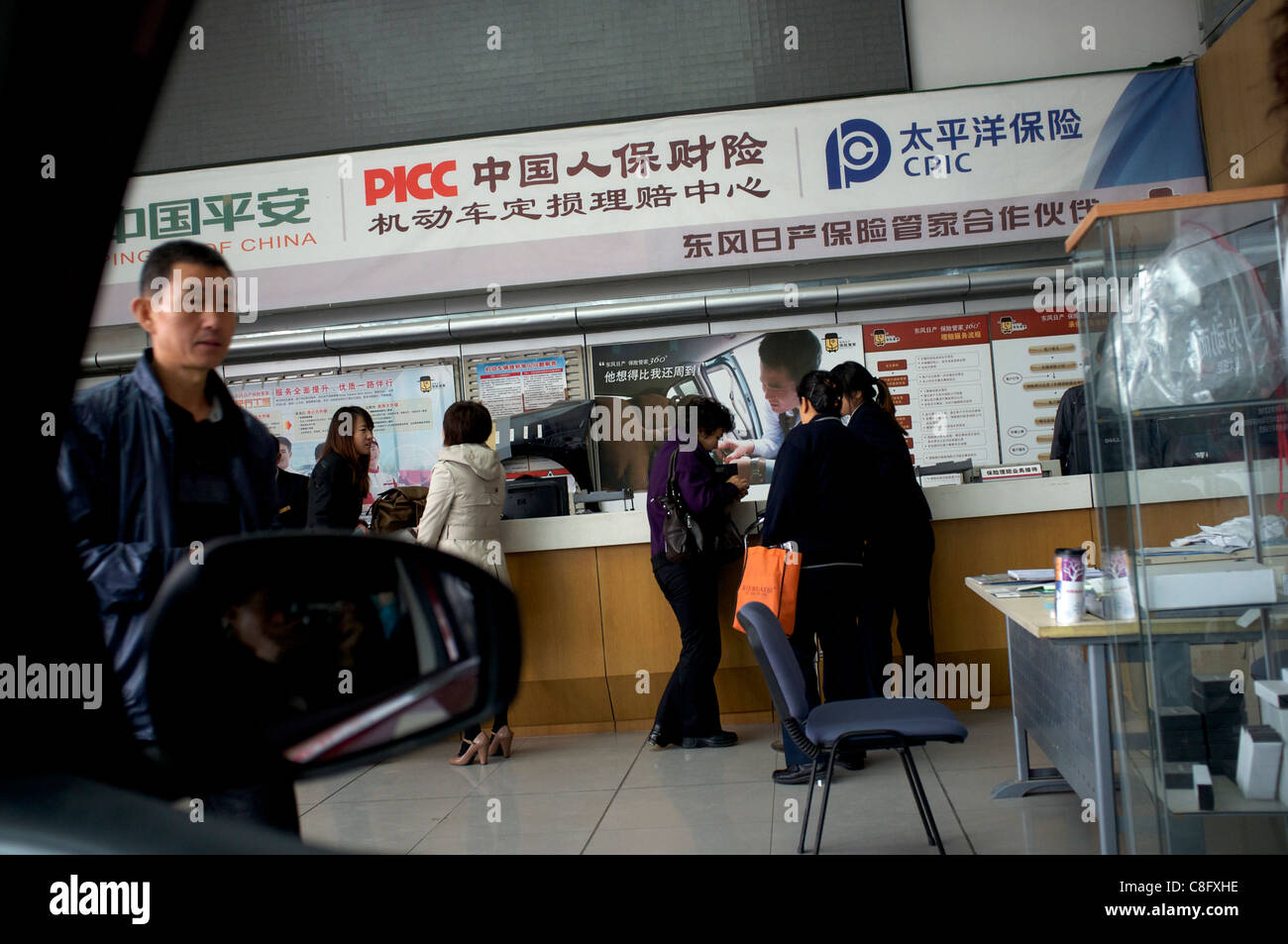 Chinese commercial vehicle insurance agents serve clients in Beijing, China. 22-Oct-2011 Stock Photo