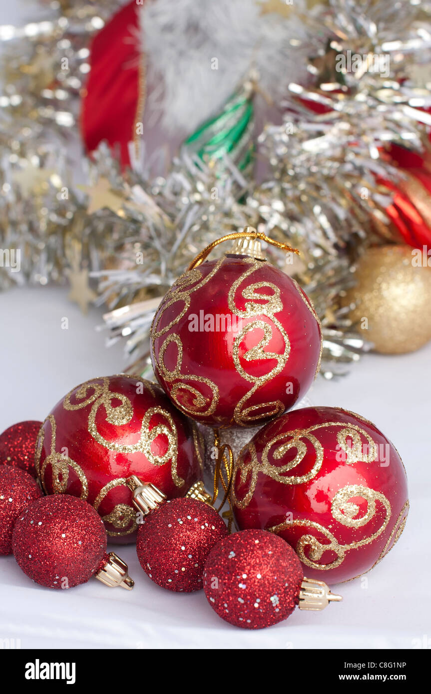 Christmas motifs with balls and chains. Red and white balls, white chains and red ribbon Stock Photo