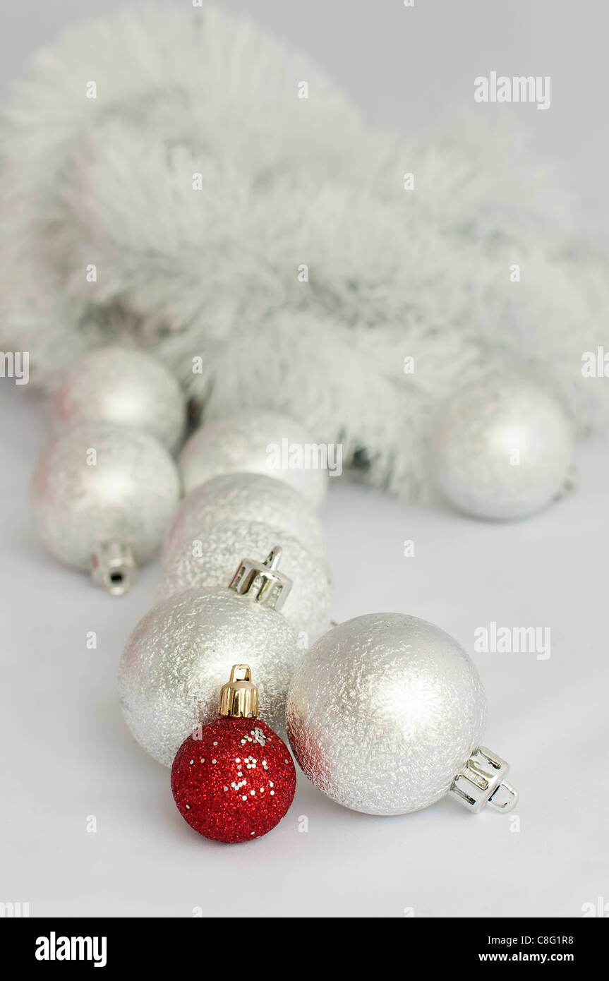 Christmas motifs with balls and chains. Red and white balls, white chains and red ribbon Stock Photo