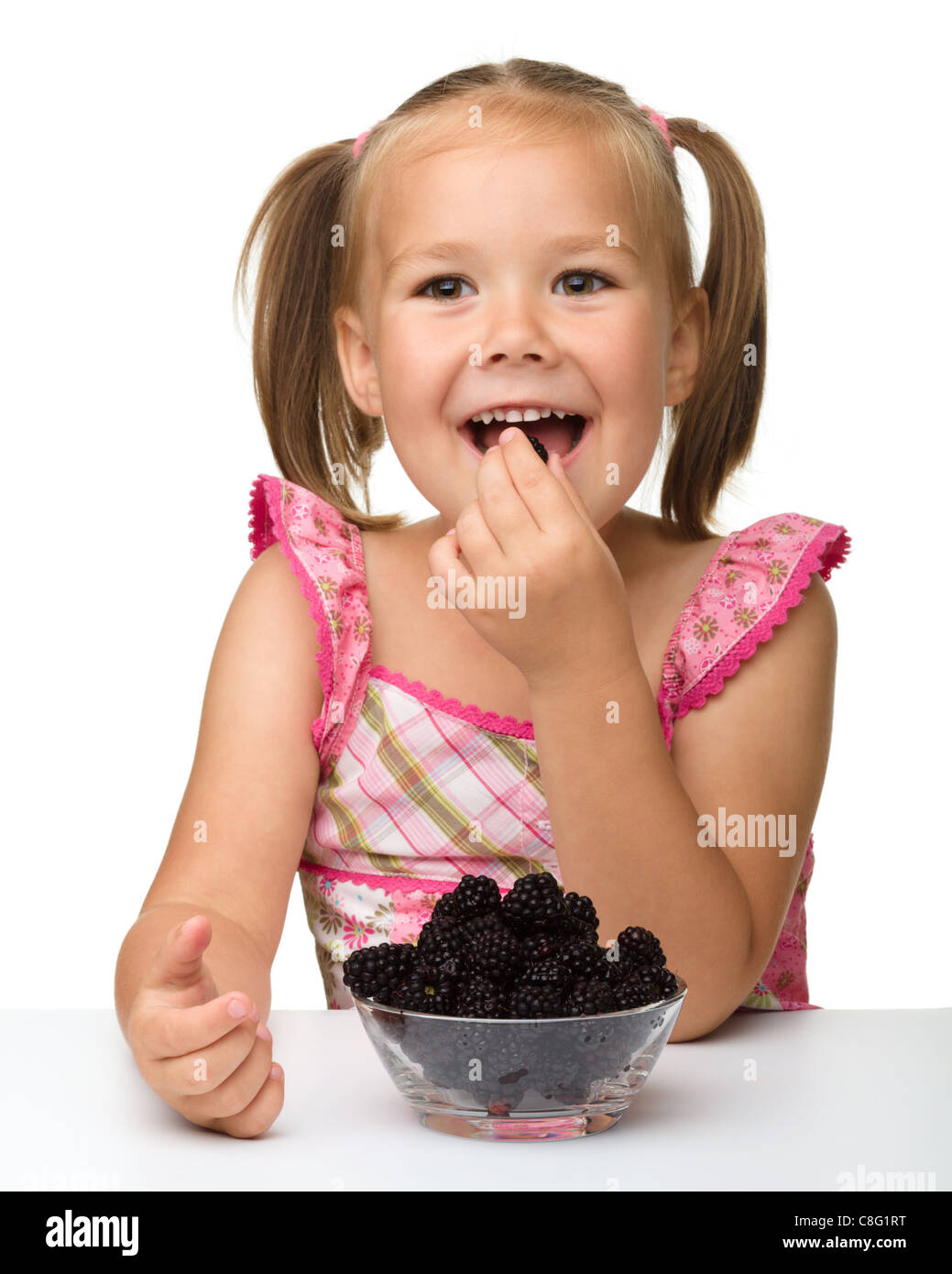 Little child eating blackberries hires stock photography and images