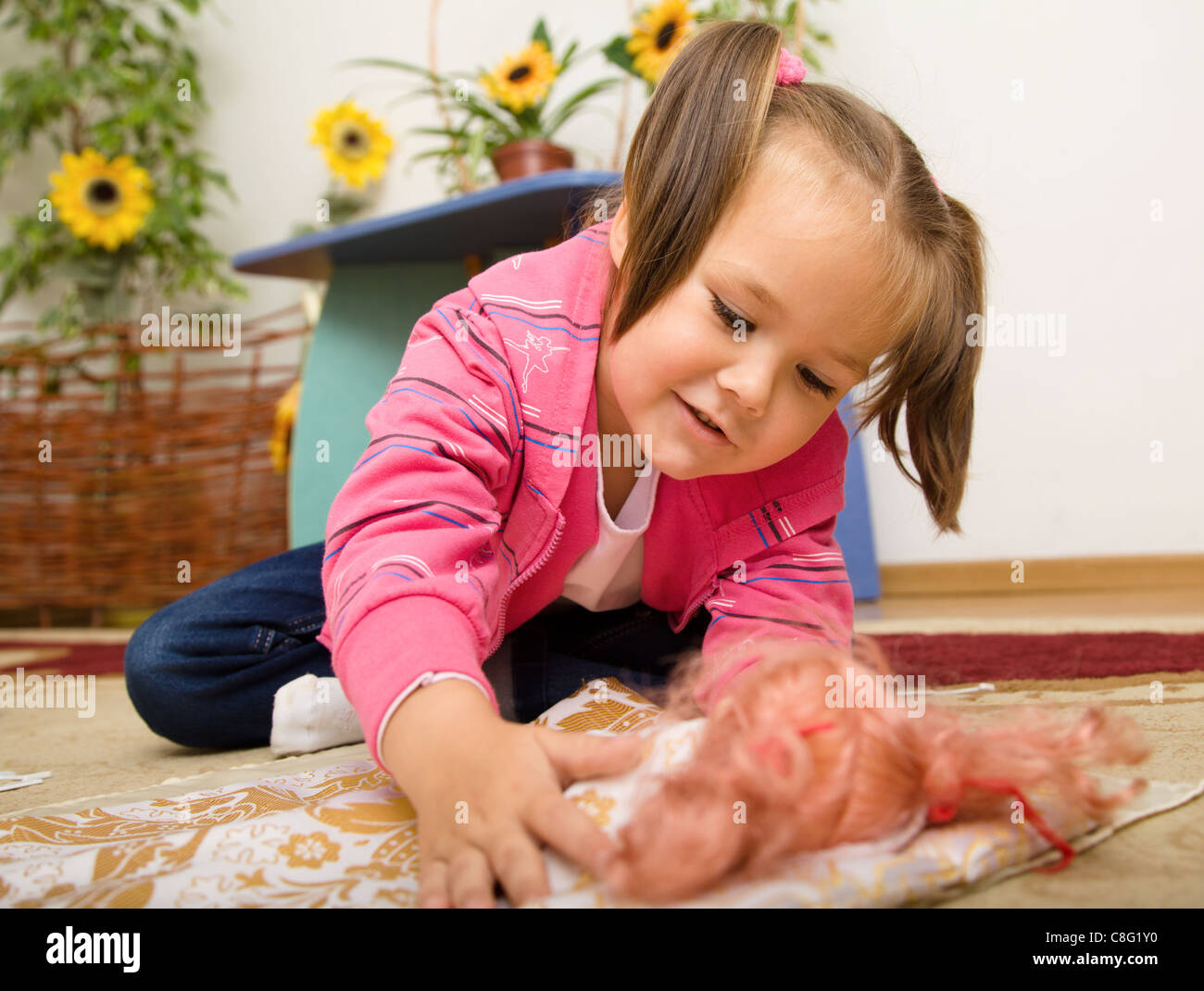 Girl putting doll to sleep hires stock photography and images Alamy