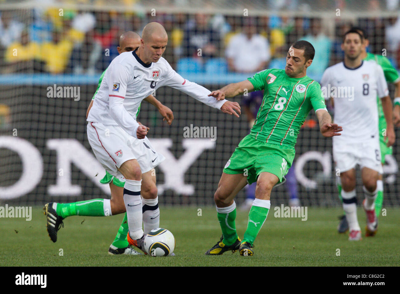Medhi Lacen of Algeria (R) defends against Michael Bradley of the United States (L) during a 2010 FIFA World Cup Group C match. Stock Photo
