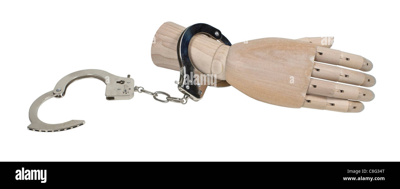 Wooden hand wearing handcuffs made of metal with mechanical clasp - path included Stock Photo