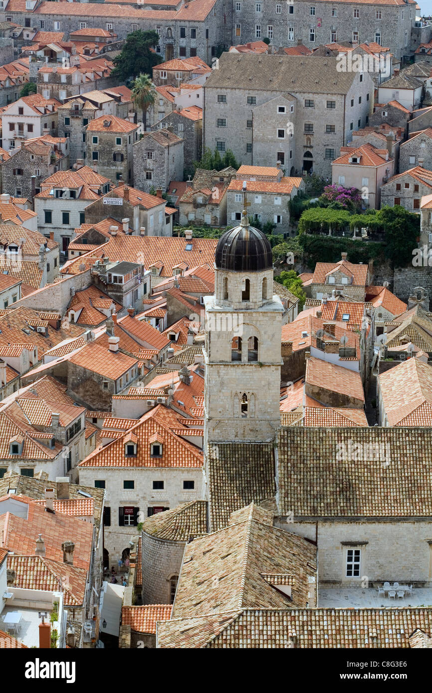 The bell tower of the Franciscan Monastery and red tiled rooftops above ...