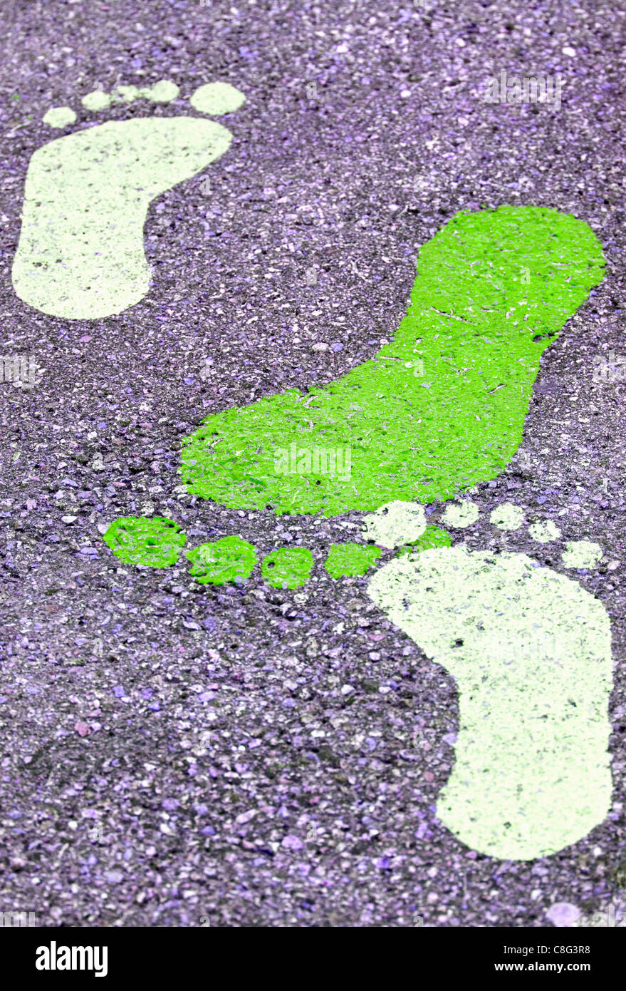 Coloured footprints painted onto a pavement Stock Photo