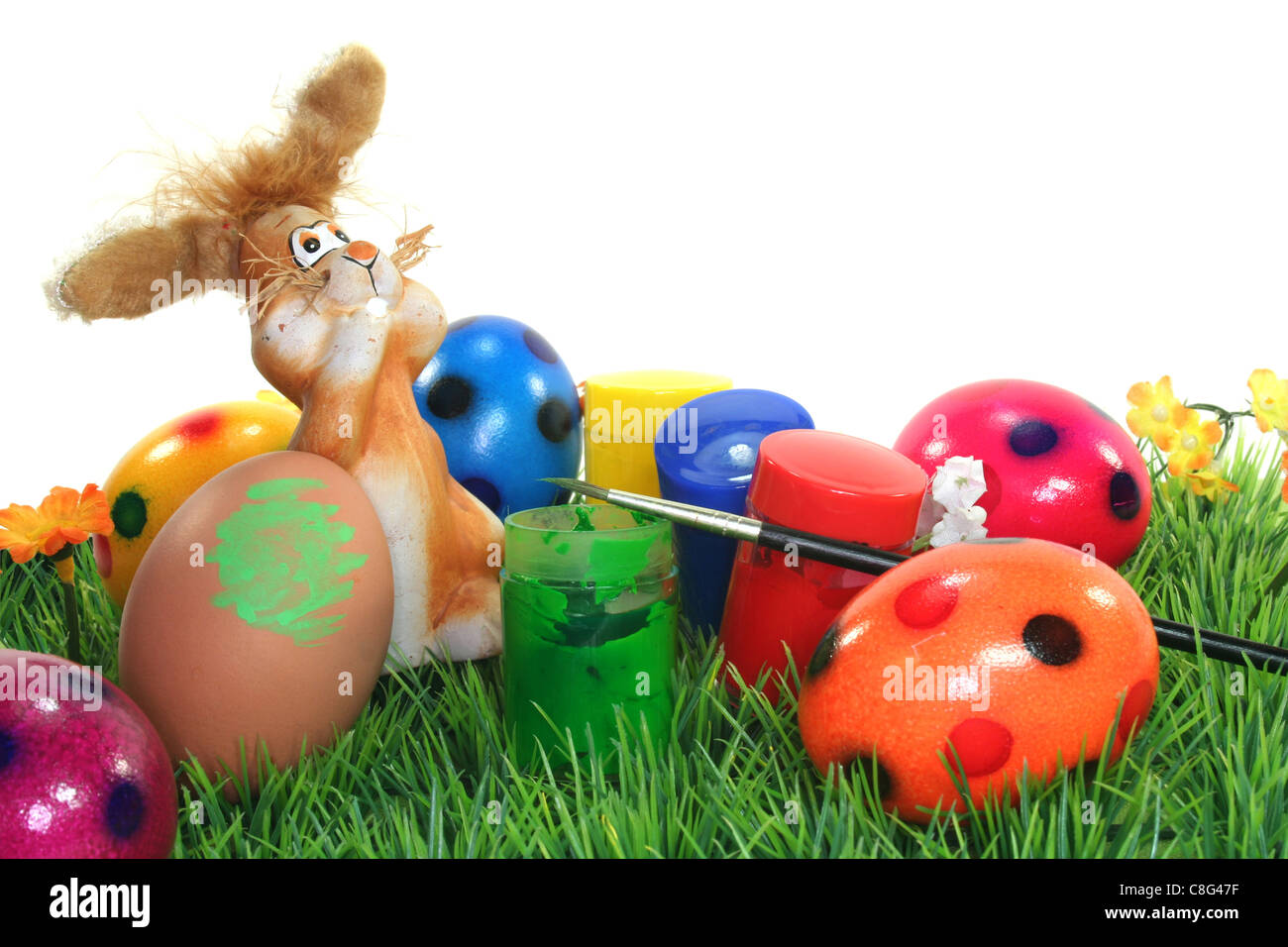 Easter Bunny on a flower lawn with colors and eggs Stock Photo - Alamy