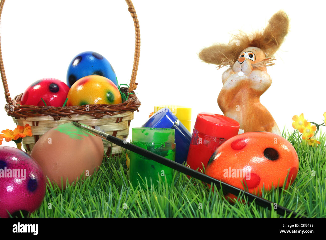 Easter Bunny on a flower lawn with colors and eggs Stock Photo - Alamy