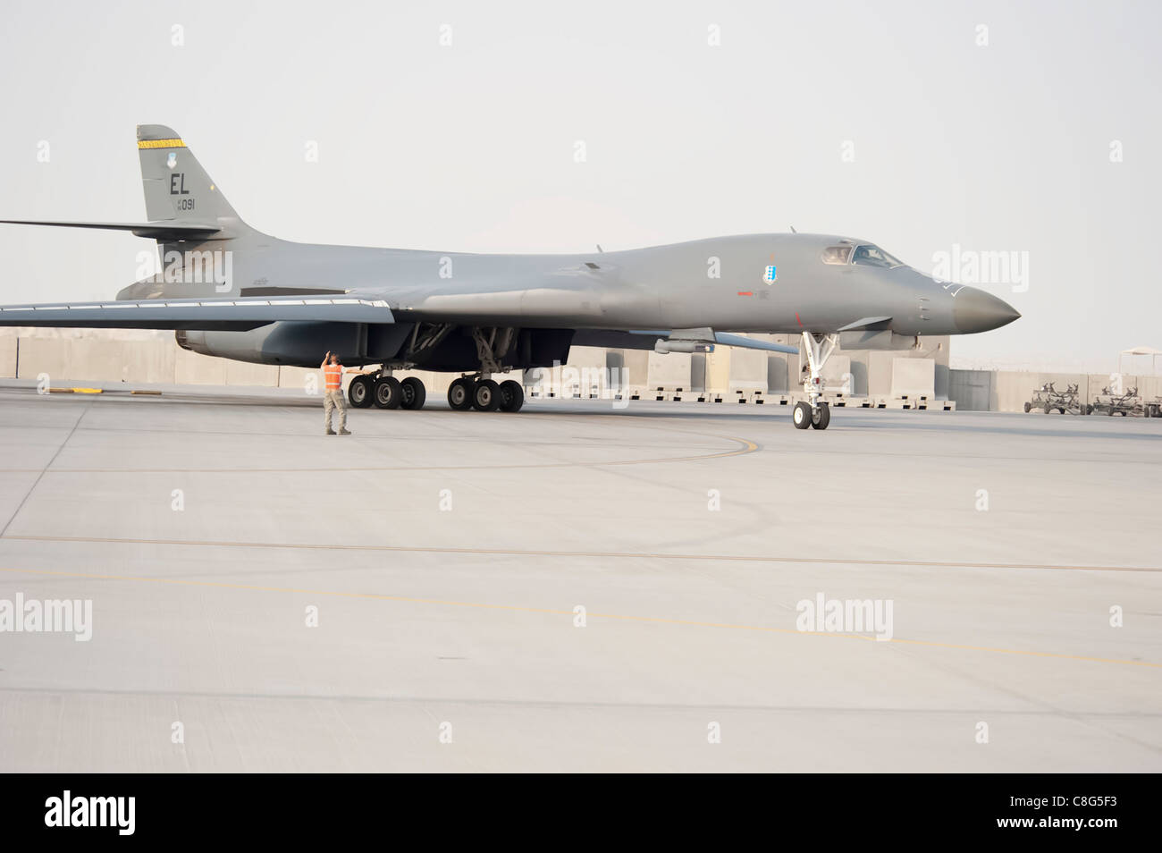 Staff Sgt. Daniel Gordon marshals a B1-B Lancer as it taxis at an air base in Southwest Asia before a combat mission Nov. 11, 2009. The multi-mission B-1 is the backbone of America's long-range bomber force. Sergeant Gordon is with the 37th Aircraft Maintenance Unit. Stock Photo