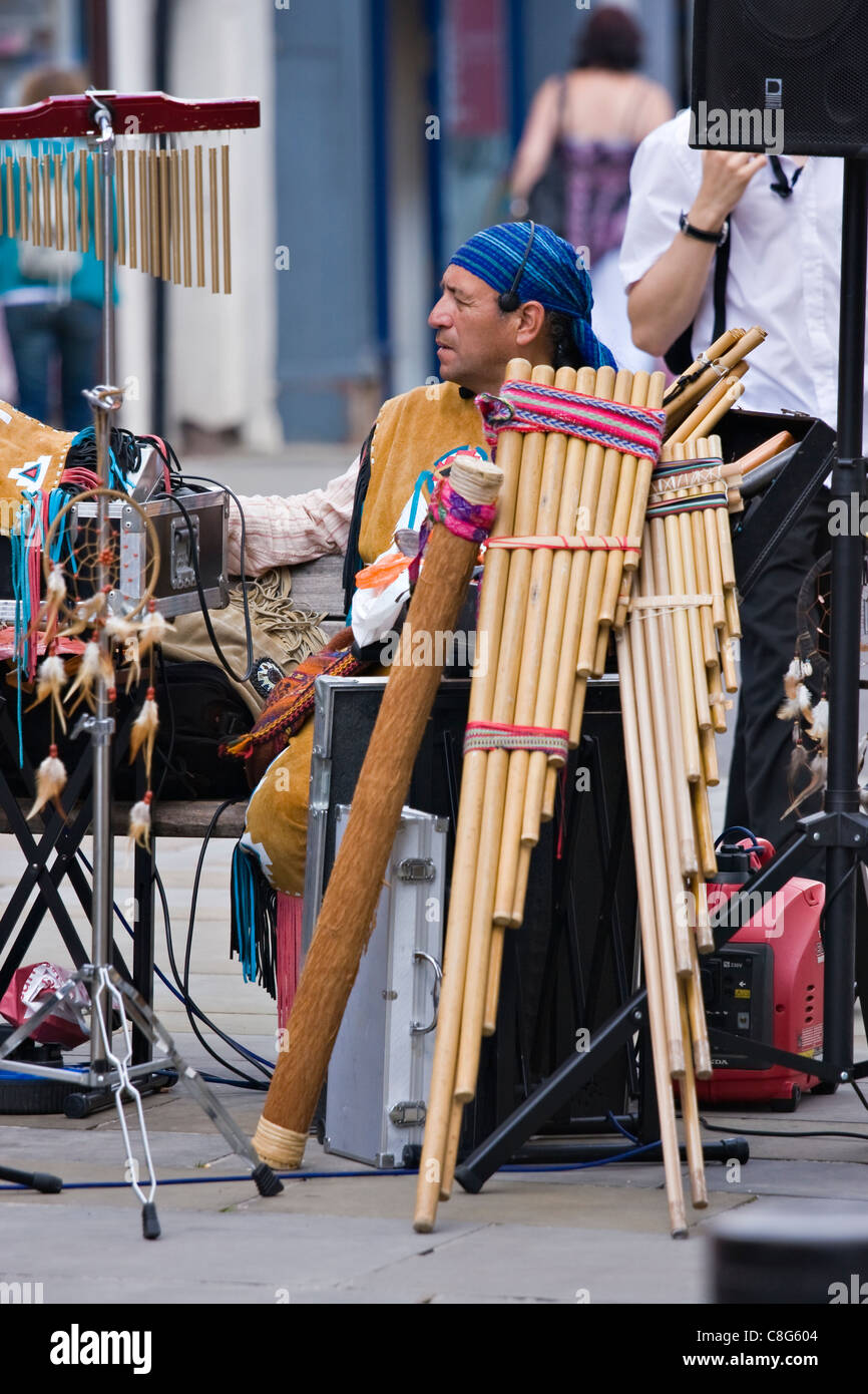 Peruvian musicians play pan pipes busking in Salisbury and playing their music to shoppers Stock Photo