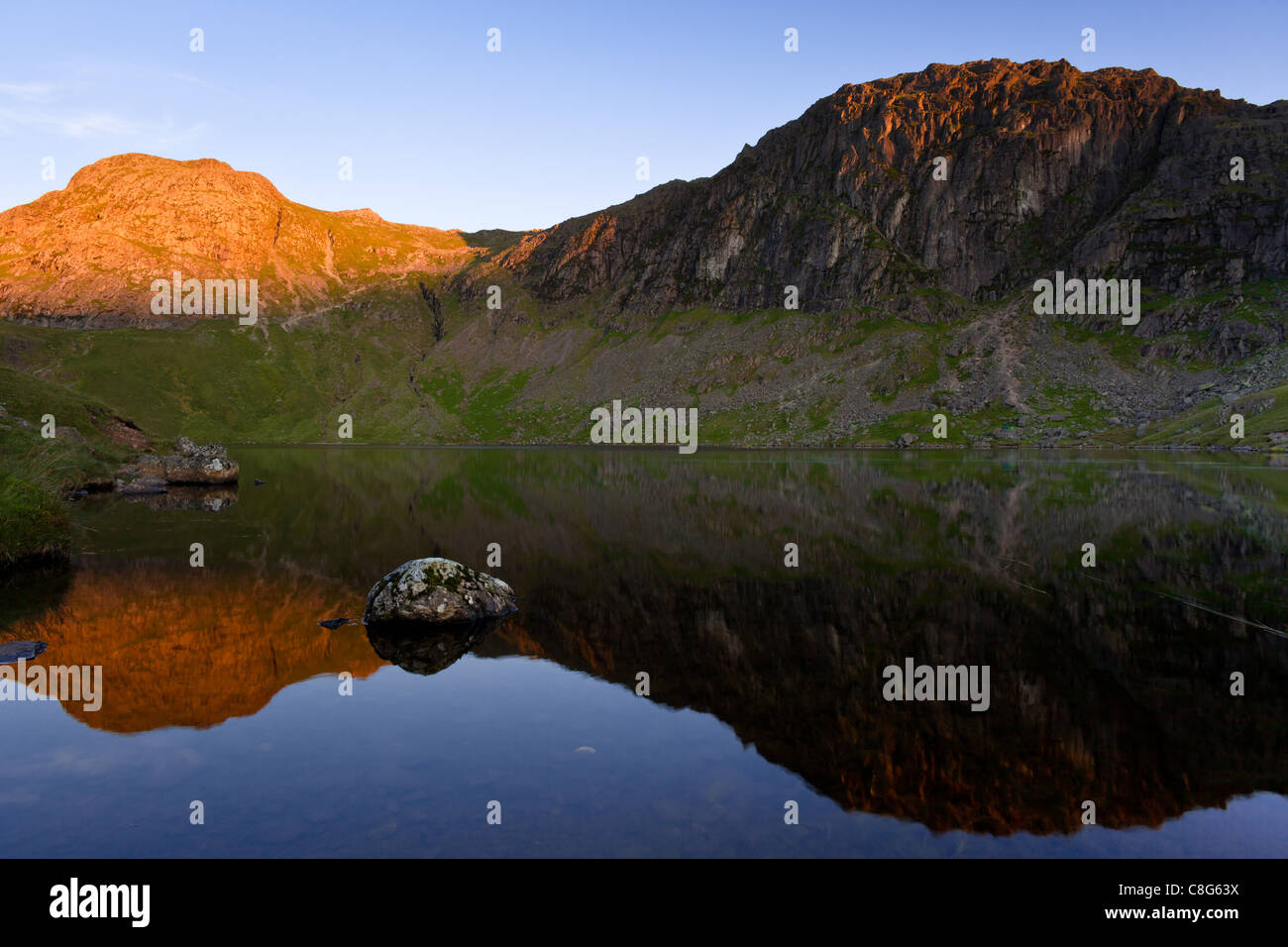 Harrison Stickle & Pavey Ark across Stickle Tarn in the English Lake District at sunrise. Stock Photo