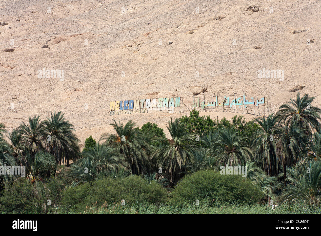 Welcome sign 'Hollywood' style with palms in front on the mountains at Sharona on the Aswan Luxor protectorate border, Egypt Stock Photo